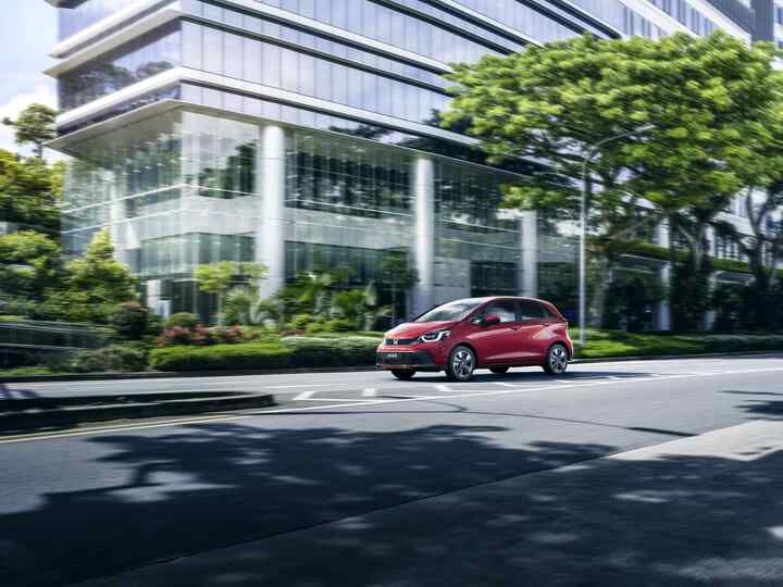  Vista da tre quarti anteriore della Honda Jazz e:HEV che percorre la strada.